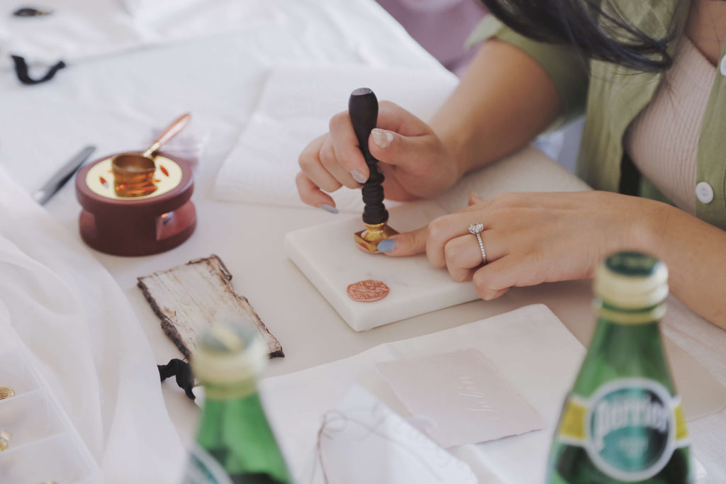 Student trying wax seal at our wax seal workshop