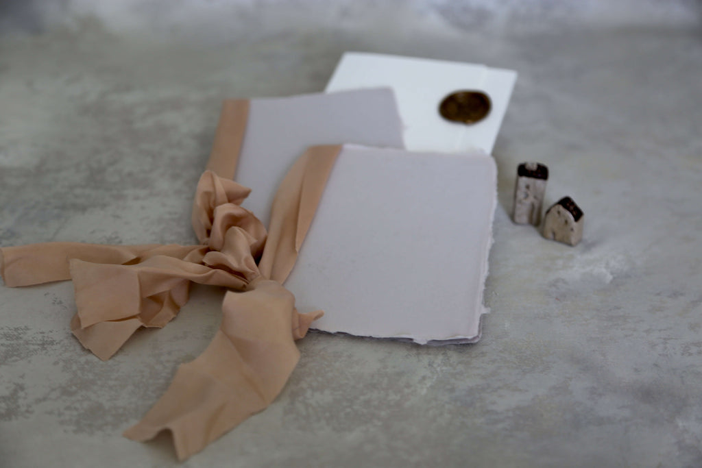 handmade paper vows booklet in light grey colour paired with cinnamon colour hand dyed natural silk ribbon